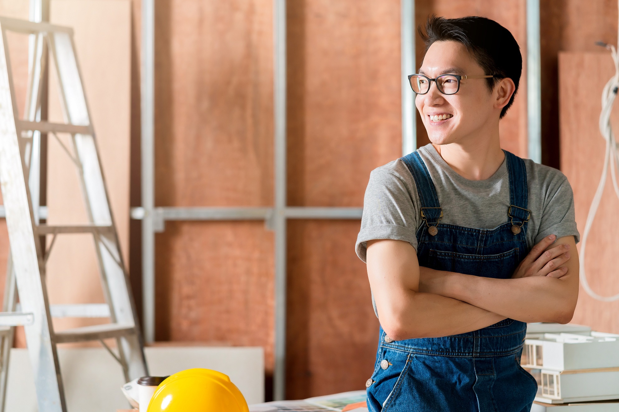 smart attractive handy glasses asian male craftman or interior designer focus wood working at site constrution home interior design renovation and improvement concept