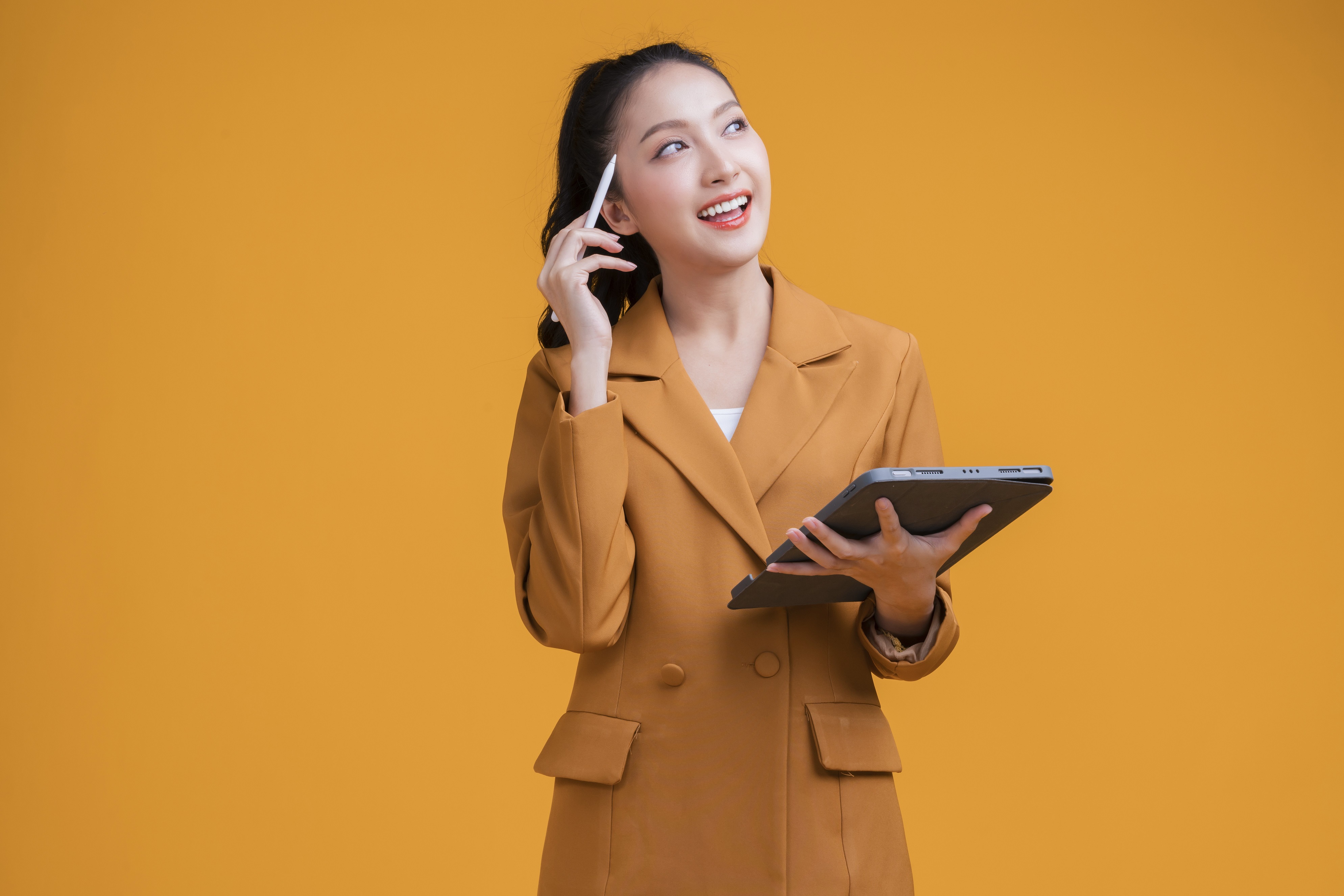casual smart asian female business woman hand using tablet business management schedule smiling confident cheerful facial expression studio shot yellow background,thinking asian woman in formal cloth